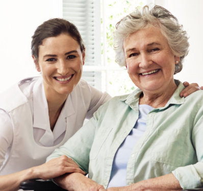 elderly woman smiling with caretaker