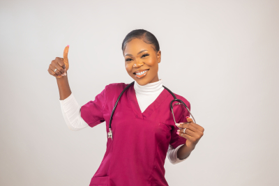 American doctor with a stethoscope giving a thumbs up isolated over a white background